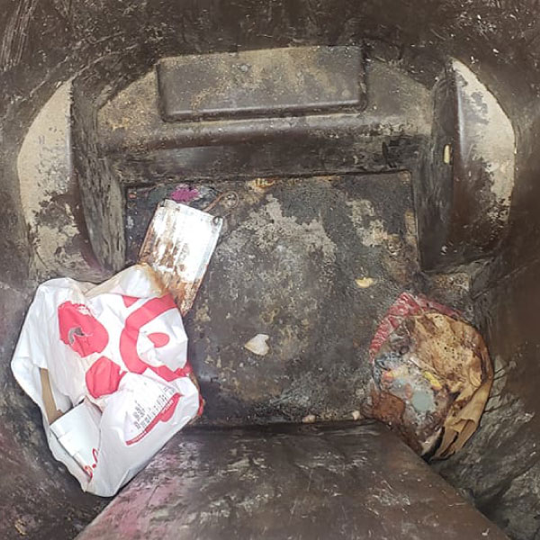 Dirty trash bin with trash stuck to the bottom and smelly odors before getting cleaned by BinRefresh
